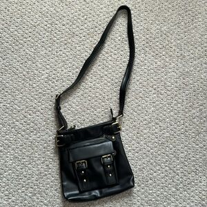 Black crossbody purse with a lot of room and many compartments;